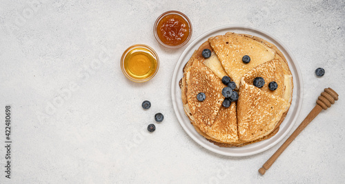Homemade thin pancakes. Traditional Russian or Ukrainian homemade fried crepes. Light stone background