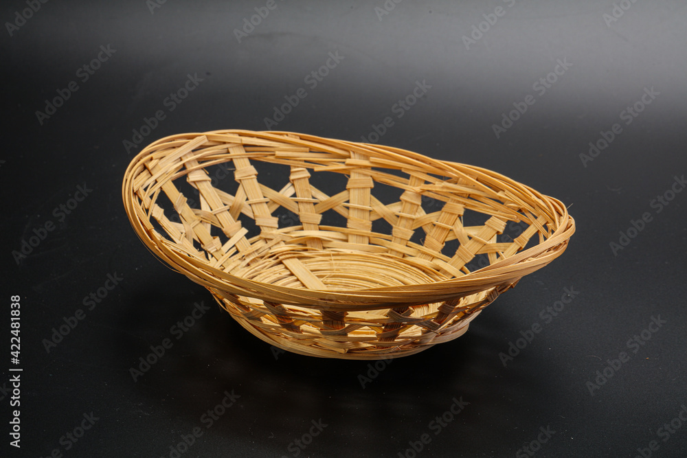 Natural wicker tableware for serving over black Natural wicker tableware for serving over black