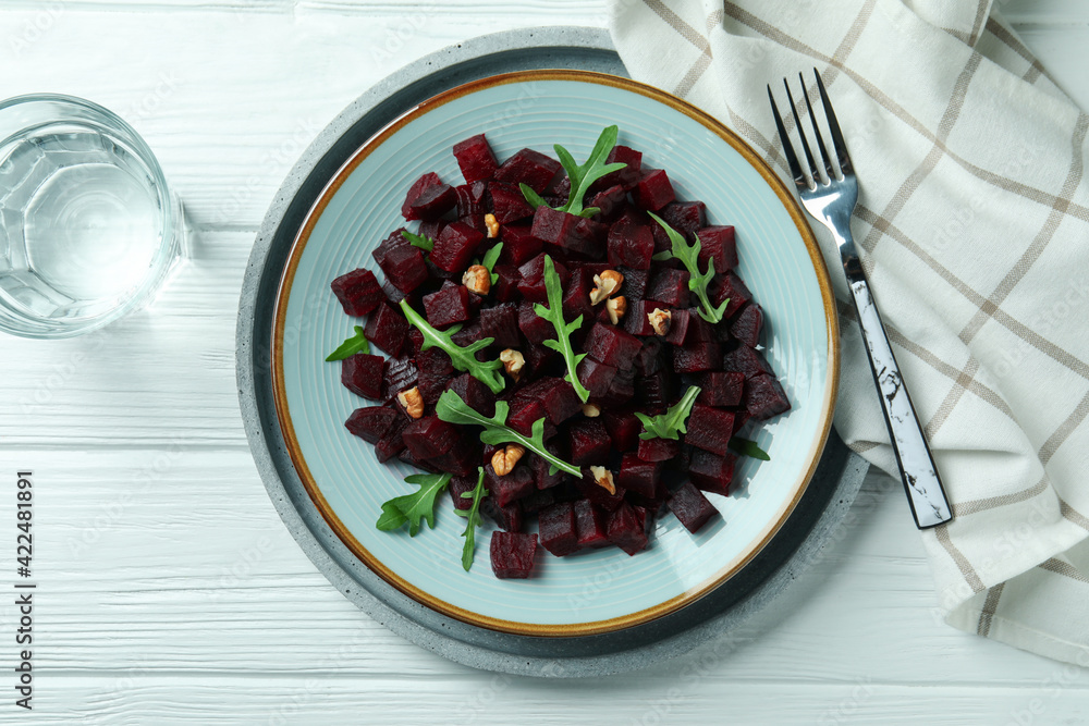 Concept of tasty eating with beet salad on wooden background