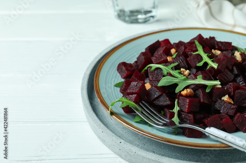 Concept of tasty eating with beet salad on wooden background