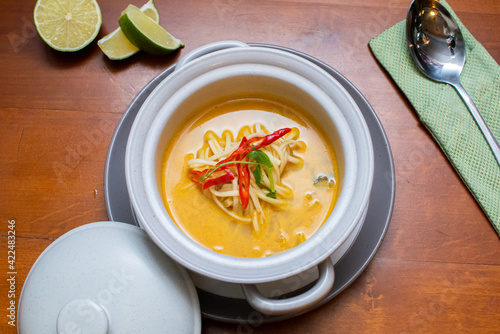 Tom Yam kung Spicy Thai soup with seafood, coconut milk and chili pepper 
