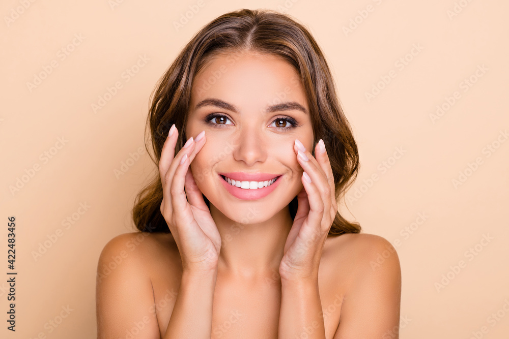 Photo of nice long hairdo optimistic lady without clothes touch face isolated on pastel beige color background Photo of nice long hairdo optimistic lady without clothes touch face isolated on pastel beige color background
