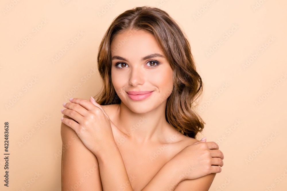 Photo of nice long hairdo optimistic lady without clothes hug isolated on pastel beige color background Photo of nice long hairdo optimistic lady without clothes hug isolated on pastel beige color background