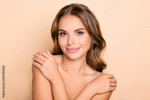 Photo of nice long hairdo optimistic lady without clothes hug isolated on pastel beige color background