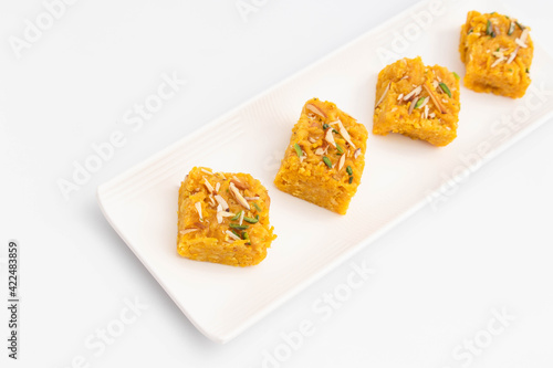 Sindhi Indian Mithai Sev Badam Halwa Burfi Barfee Or Barfi Is Made Of Bengal Gram Flour Besan Kaju Kesar Pista Khoya Meetha Doodh Mawa Malai In Desi Ghee. Isolated On White Background With Copy Space photo