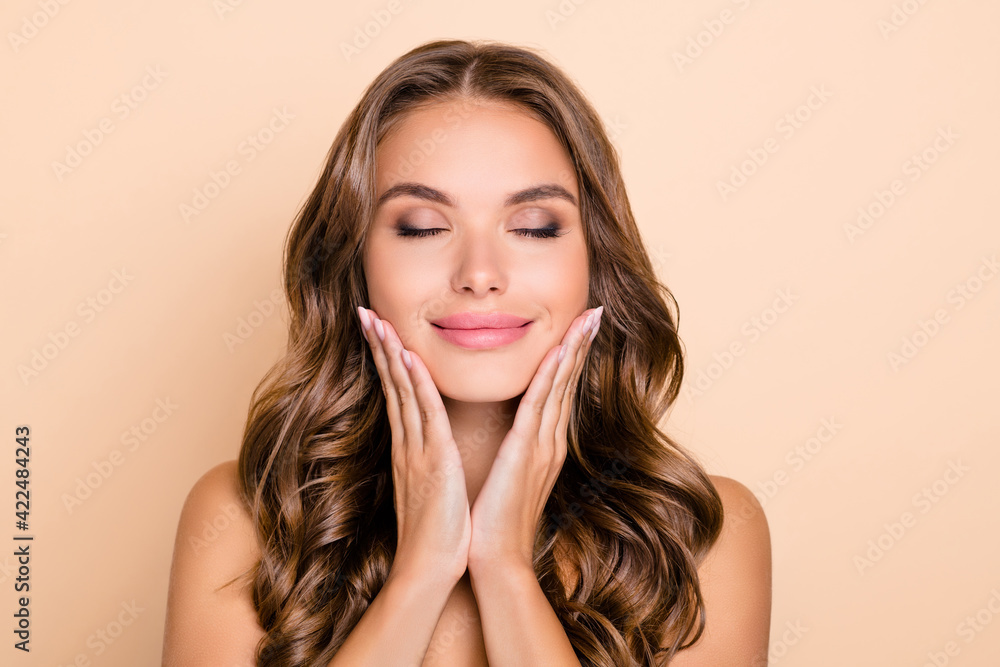 Photo of nice long hairdo optimistic lady without clothes hands face isolated on pastel beige color background Photo of nice long hairdo optimistic lady without clothes hands face isolated on pastel beige color background