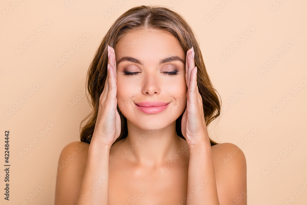Photo of nice long hairdo optimistic lady without clothes hands face closed eyes isolated on pastel beige color background Photo of nice long hairdo optimistic lady without clothes hands face closed eyes isolated on pastel beige color background