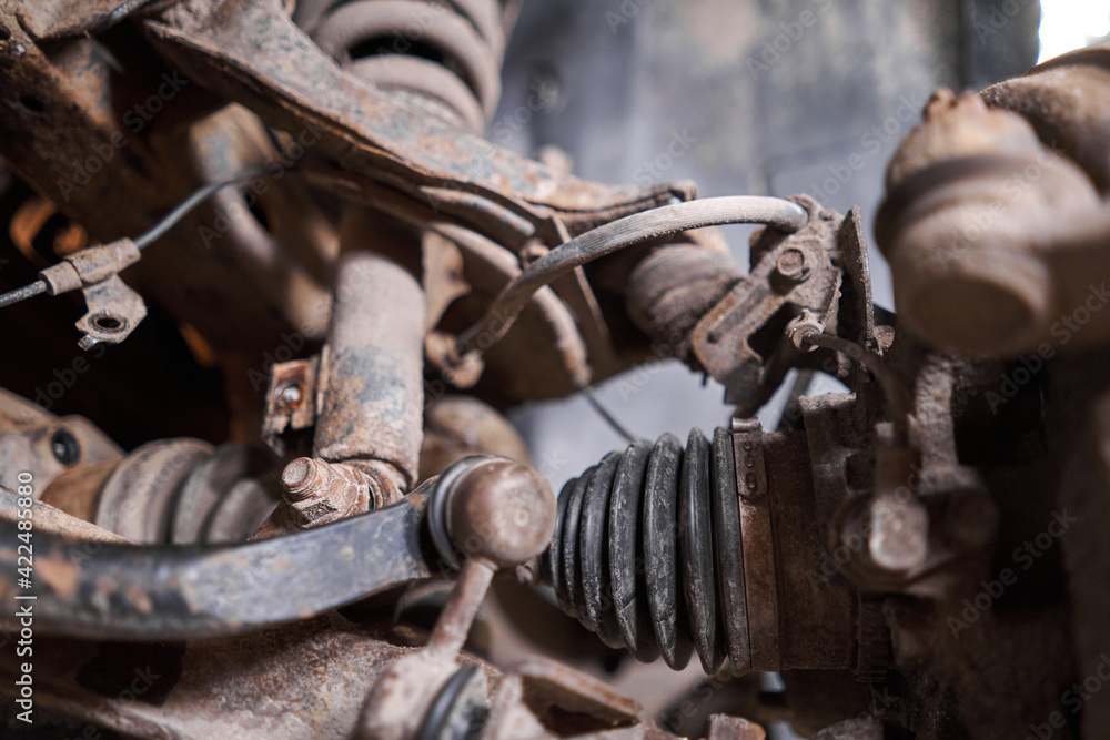 Inspects suspension, steering parts, tie rod ends. Car on a repair stand. Technical service station for car. Inspects suspension, steering parts, tie rod ends. Car on a repair stand. Technical service station for car.