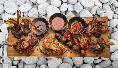 grilled meat on a large cooking board 