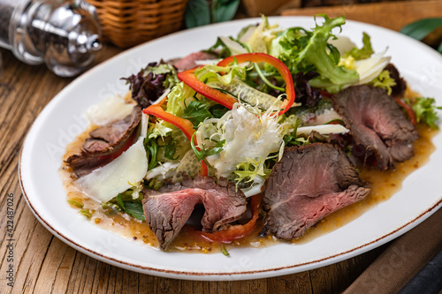 Meat salad with lettuce, pepper and parmesan 