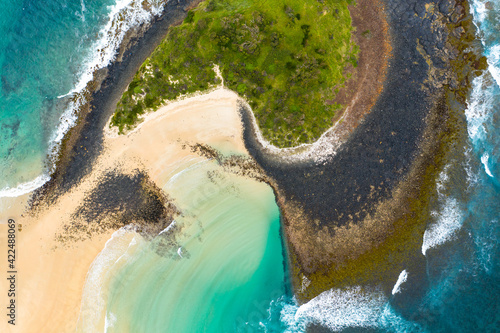 Aerial top down shot of the beach patterns and colors of the calm bay on the west side of Green Island at Cunjurong Point New South Wales Australia photo