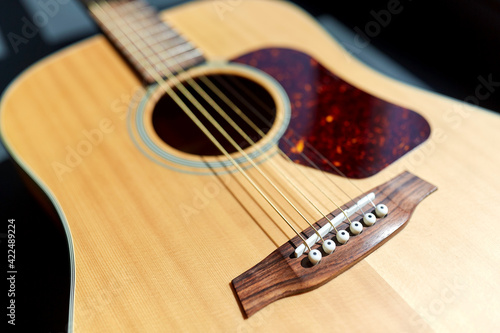 close up of acoustic guitar on window sill