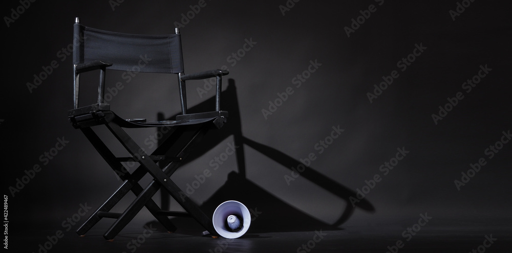 Black director chair and Clapper board or movie Clapperboard on black background.use in video production or film cinema industry Black director chair and Clapper board or movie Clapperboard on black background.use in video production or film cinema industry