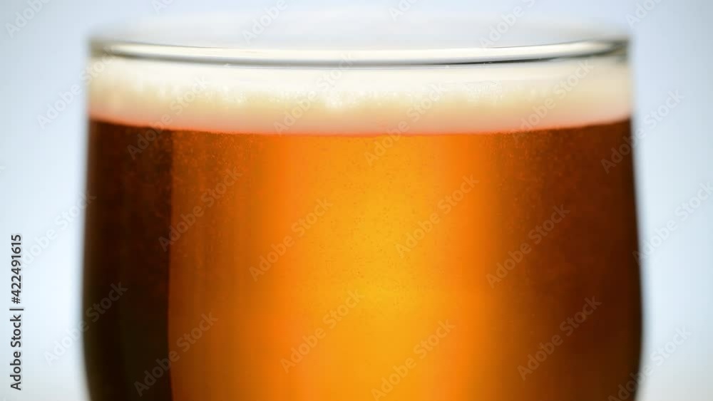 Beer is pouring into the glass. Cold ale Beer are flowing in the glass Beer is pouring into the glass. Cold ale Beer are flowing in the glass