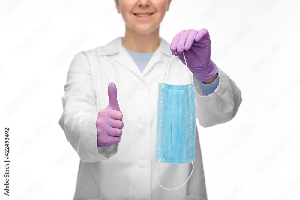 female doctor with medical mask showing thumbs up female doctor with medical mask showing thumbs up
