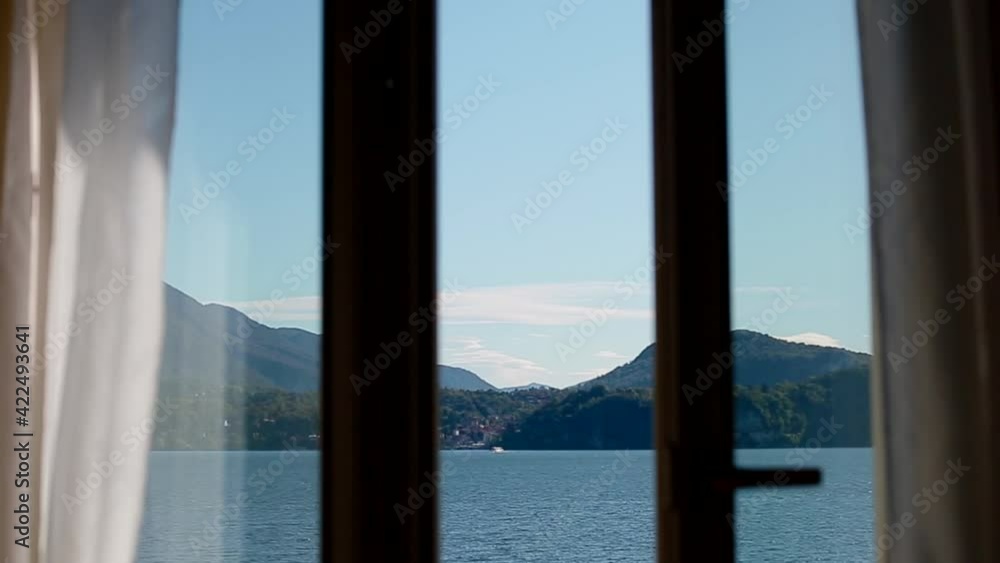 View of Lago Maggiore through closing window. Chamber influx. View of Lago Maggiore through closing window. Chamber influx.