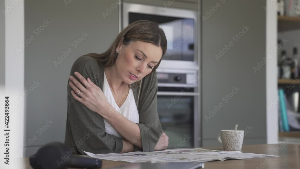 Woman at home relaxing and reading newspaper Woman at home relaxing and reading newspaper