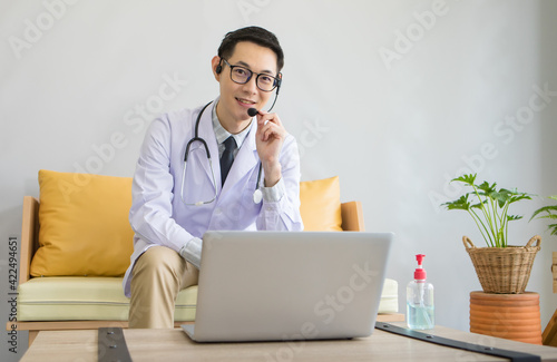 Young Asian doctor giving online consultation