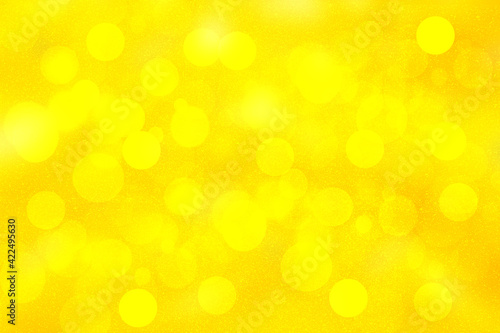 A festive abstract delicate golden yellow gradient background texture with glitter defocused sparkle bokeh circles. Card concept for Happy New Year, party invitation, valentine or other holidays.