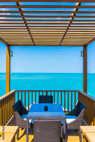 Outdoor patio with empty chair and table with sea ocean view