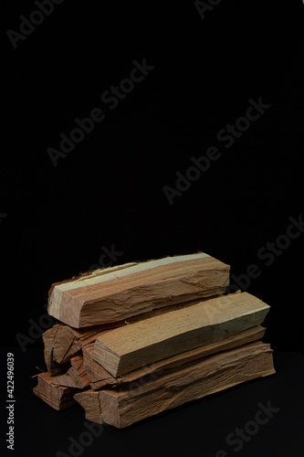 Firewood on a black background. Firewood for the stove or fireplace. Natural resource.