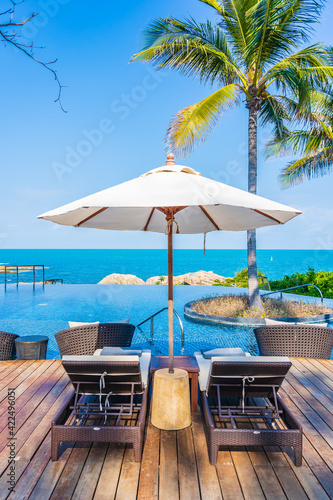 Umbrella and chair around outdoor swimming pool in hotel resort © siraphol