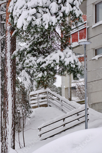 Obraz na płótnie The snow-covered yard of the residential apartment building after a strong snow-storm in Finland. w salonie