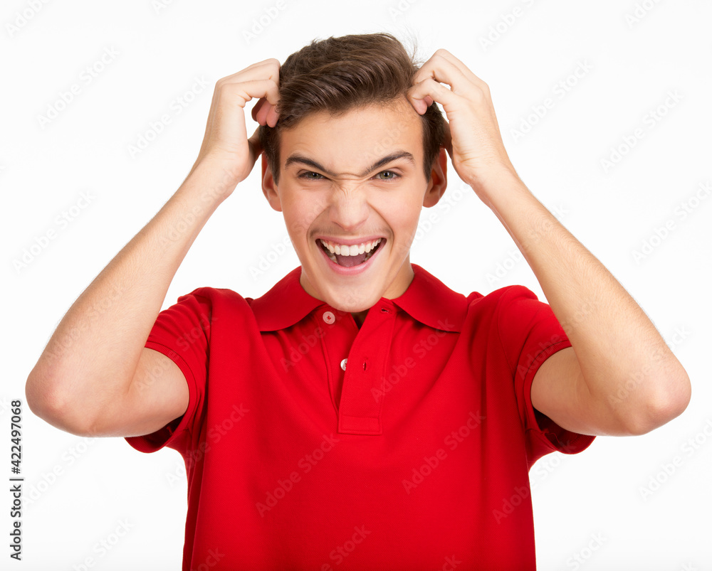 Photo of young screaming man looking at camera isolated on white background. Portrait of handsome guy touching his head with a expressive emotions . Funny portrait of Teenager . Photo of young screaming man looking at camera isolated on white background. Portrait of handsome guy touching his head with a expressive emotions . Funny portrait of Teenager .