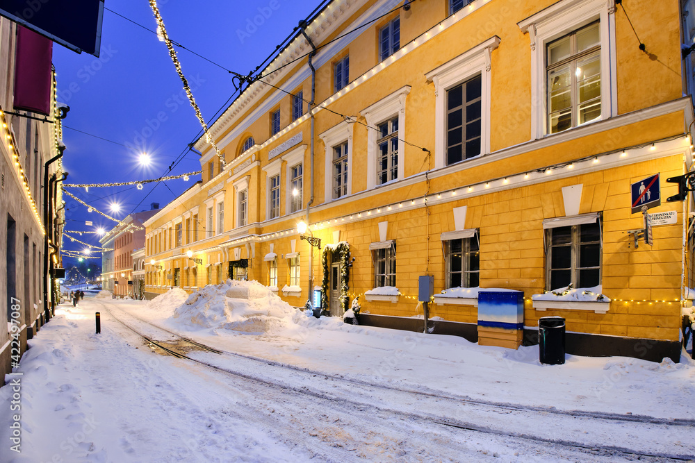 Snow-covered street decorated for Christmas in Central Helsinki, Finland.