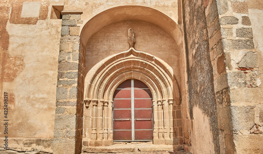 main door of a catholic chapel with non original iron and wood veneer door