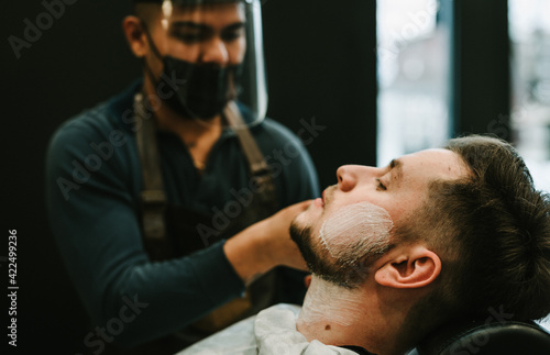 barber applying shaving cream