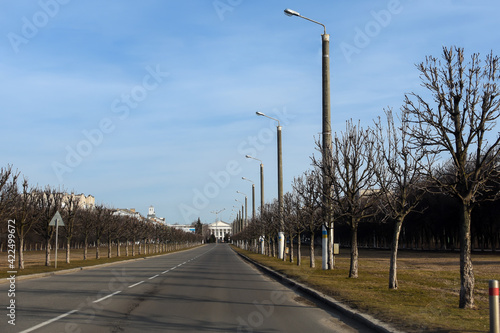 The road in the city in the spring on a bright sunny day. Lampposts along the road.