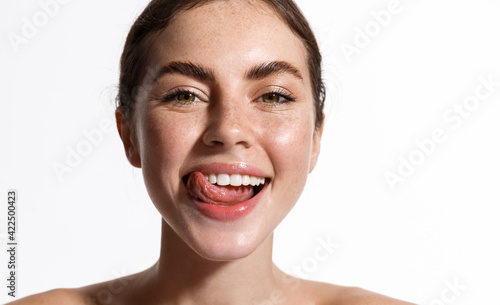 Fényképezés Beauty face of girl showing perfect white healthy smile, smiling with sticked tongue