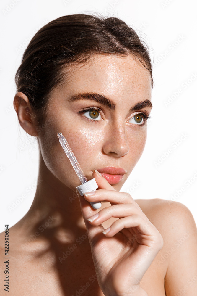 Closeup photo of beautiful naked lady hold professional cure serum bottle oil treatment cosmetologist pipette drop under eye isolated white background Closeup photo of beautiful naked lady hold professional cure serum bottle oil treatment cosmetologist pipette drop under eye isolated white background