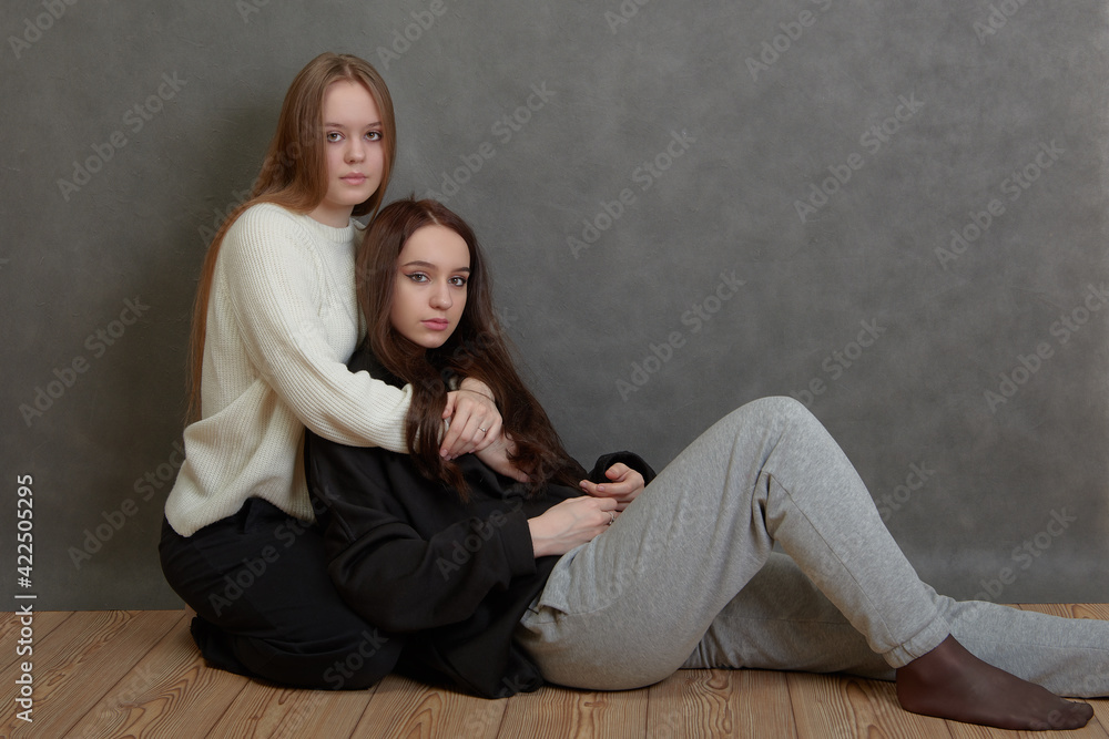 Two young women hugging and looking at camera Two young women hugging and looking at camera