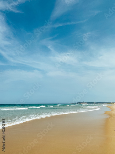 Tropical vacation concept. Soft long waves on the tropical shore of a long empty sea beach. Caribbean coast