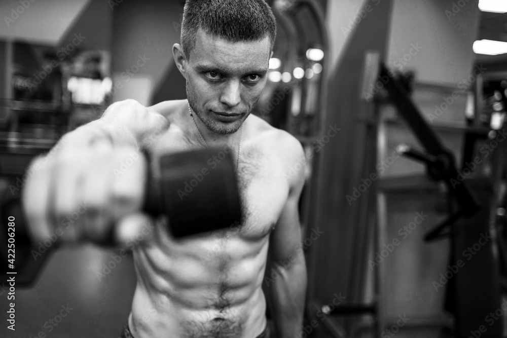 dude with muscled naked torso works his shoulders doing dumbbell swings dude with muscled naked torso works his shoulders doing dumbbell swings