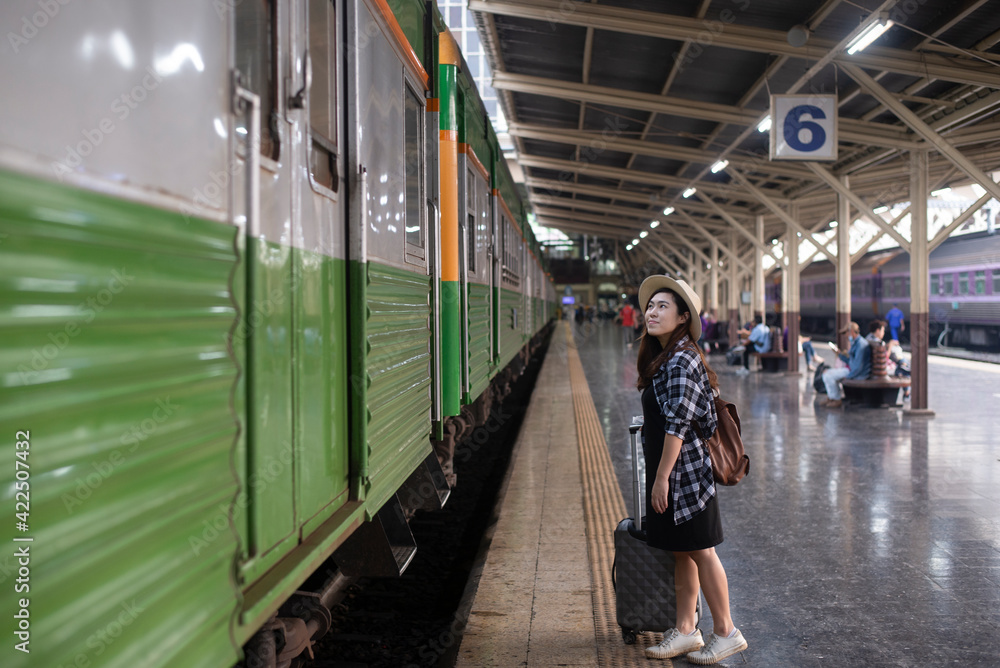 Woman traveler waiting with luggage at Bangkok train station, Thailand. Woman traveler waiting with luggage at Bangkok train station, Thailand.
