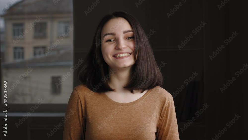 Smiling joyful caucasian brunette woman pointing finger at you posing indoor standing alone. Caucasian teen girl looking at camera with happy expression making choice gestures showing in front of her Smiling joyful caucasian brunette woman pointing finger at you posing indoor standing alone. Caucasian teen girl looking at camera with happy expression making choice gestures showing in front of her