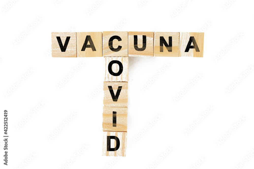 Covid-19 vaccine. Crossword with vaccine and covid. Letters on wooden blocks Covid-19 vaccine. Crossword with vaccine and covid. Letters on wooden blocks