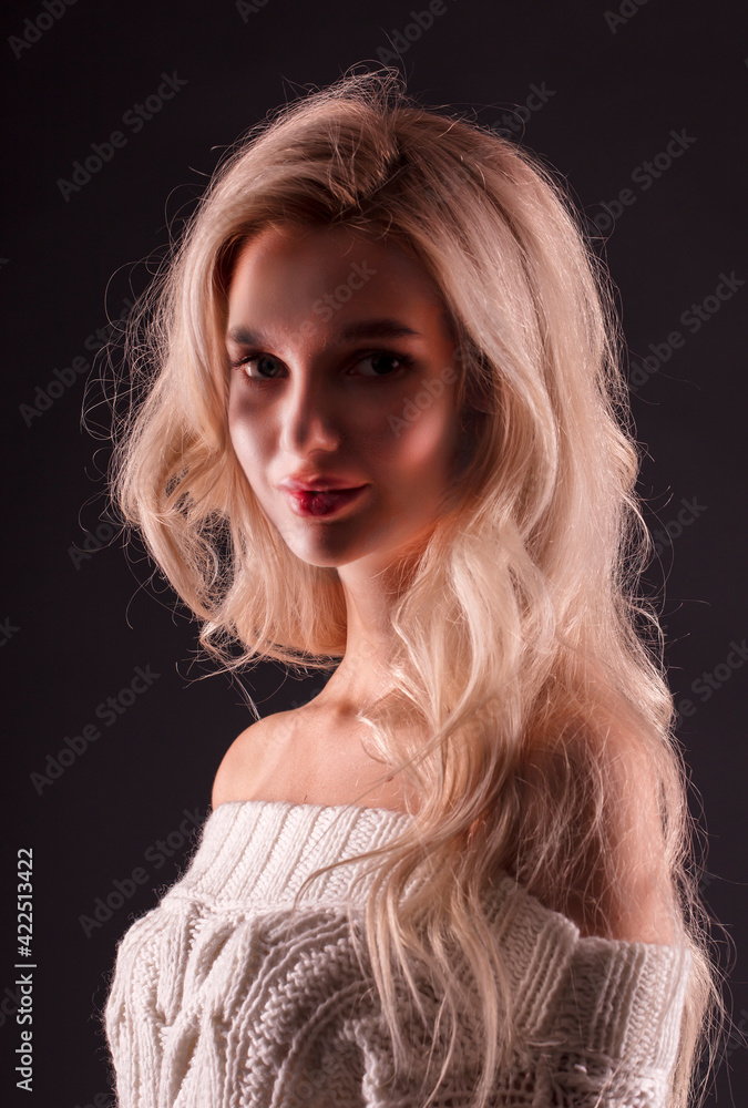 Blonde, studio portrait of a young girl