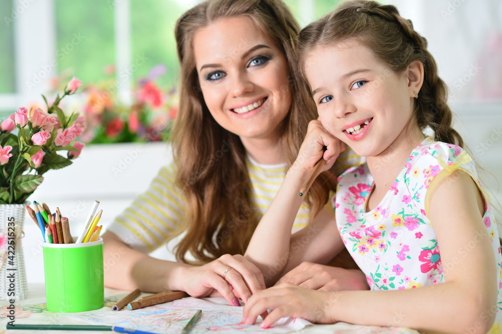 girl with mother drawing at home girl with mother drawing at home