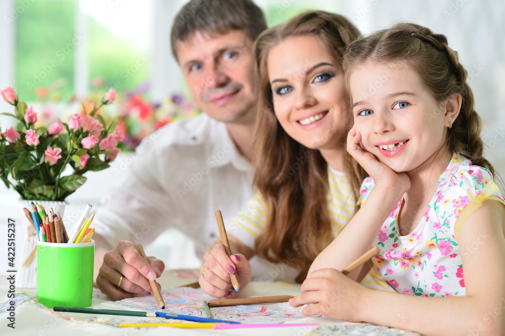 girl with mother and father drawing at home girl with mother and father drawing at home