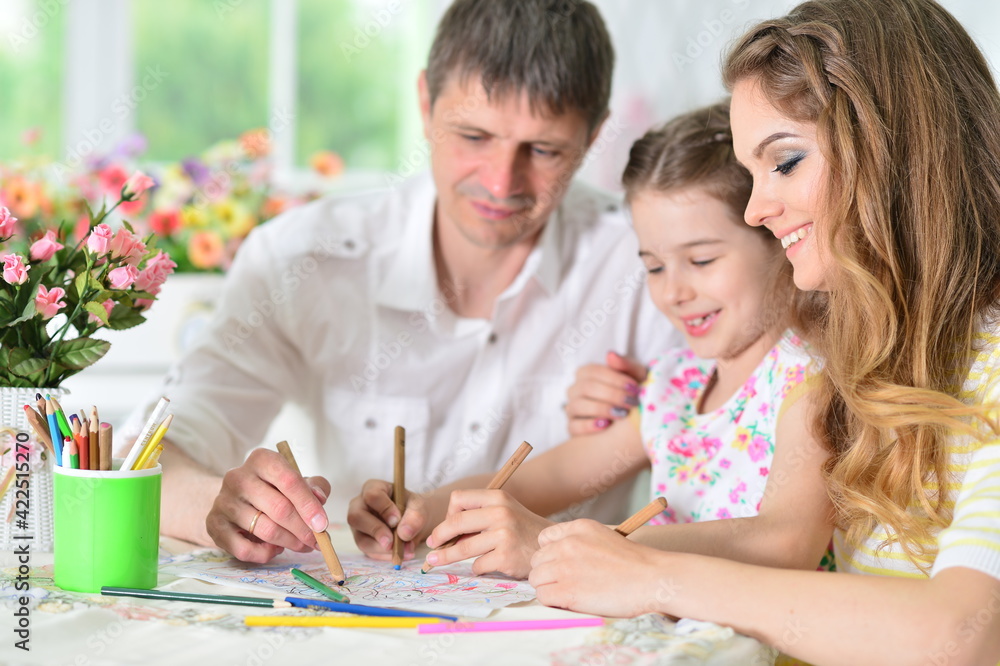 girl with mother and father drawing at home girl with mother and father drawing at home