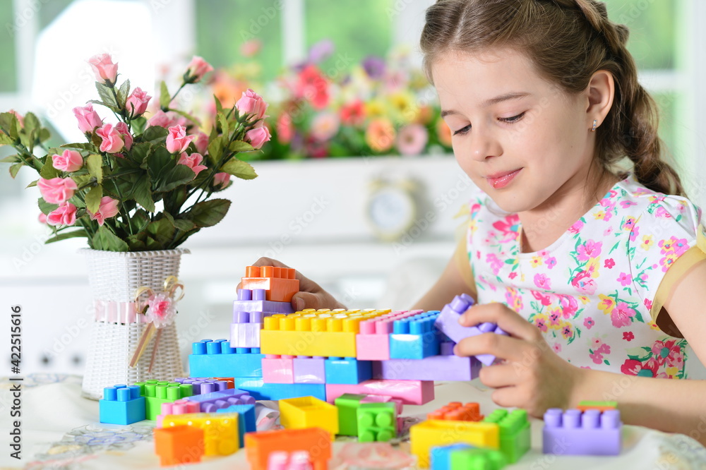girl playing with colorful plastic blocks girl playing with colorful plastic blocks