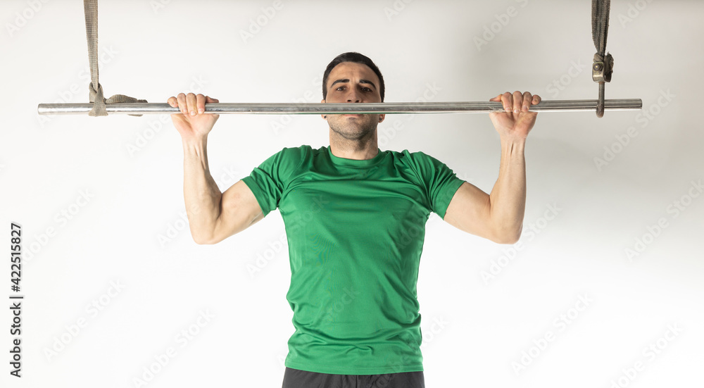 Athlete man doing pull-ups on white background. Athlete man doing pull-ups on white background.