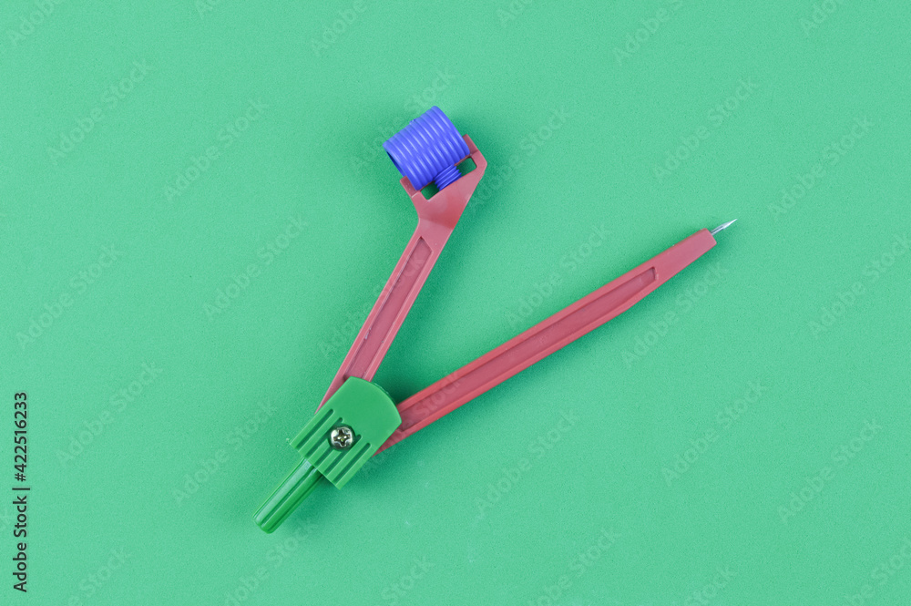 Math compass over green background Math compass over green background