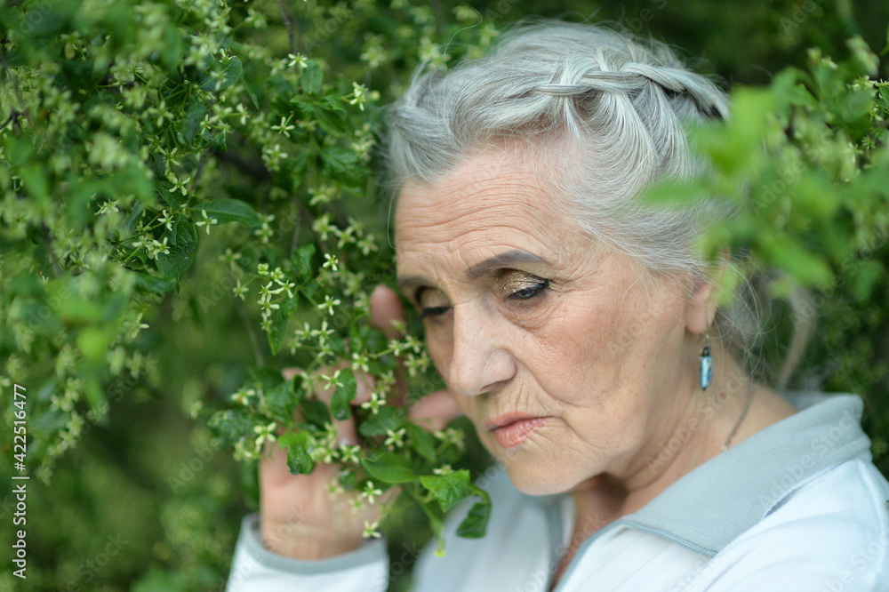 sad, thoughtful senior woman in park sad, thoughtful senior woman in park