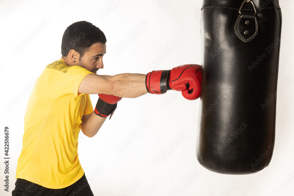 Athlete man training with boxing gloves on white background.