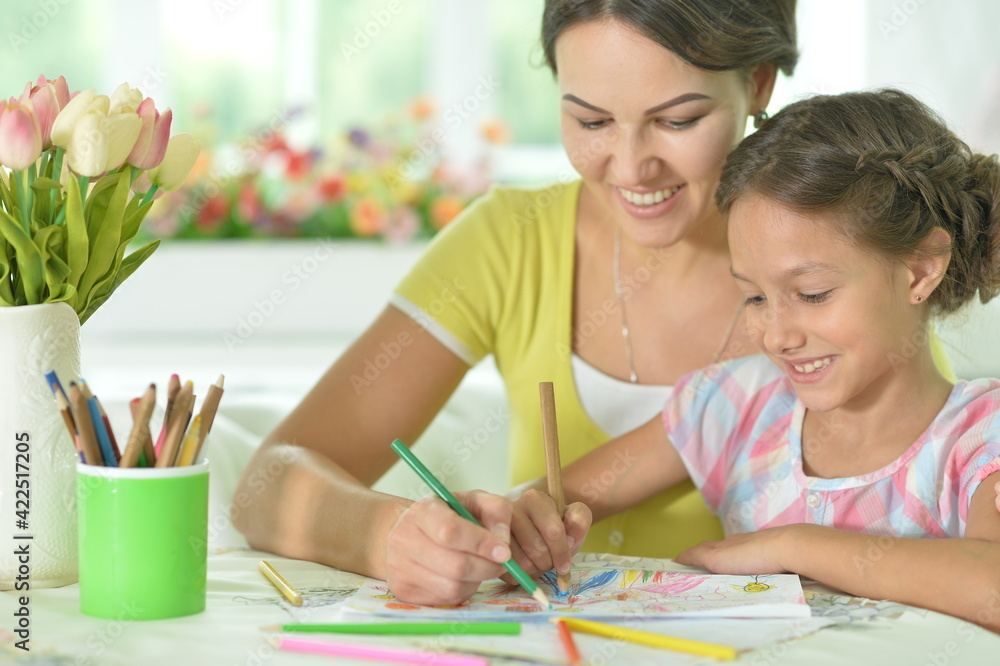 little cute girl with mother drawing at the table at home little cute girl with mother drawing at the table at home